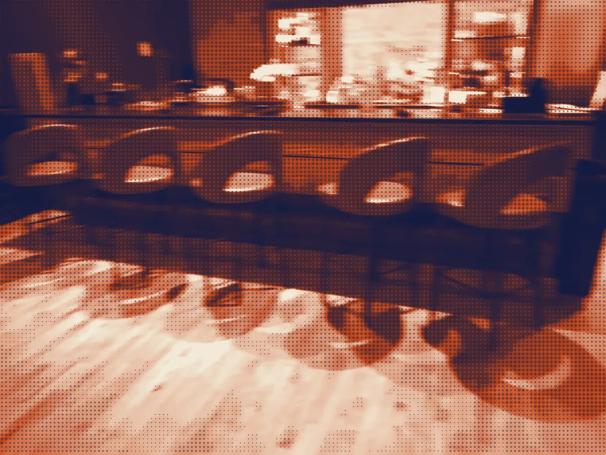 The bar, a row of round-back leather stools